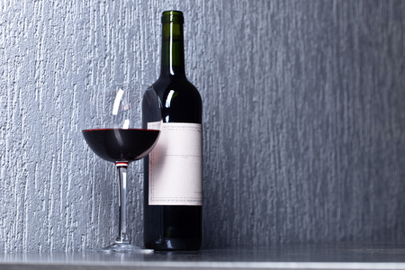 Bottle and glass of red wine . Old paper label . Copy space .の写真素材