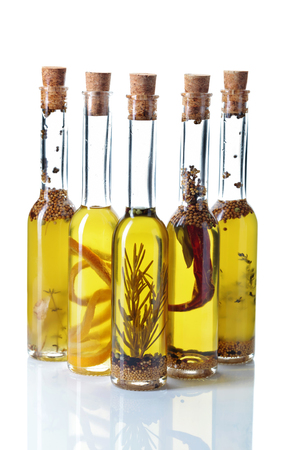 Olive oil with different spices isolated on white backgroundの写真素材