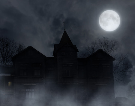 Abandoned wooden house in the moonlit night.Halloween background.の写真素材
