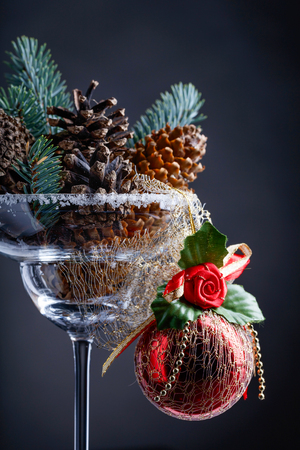 Red Christmas ball and wineglass with cones.の写真素材