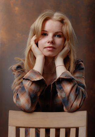  Young pretty woman in brown plaid shirt .の写真素材