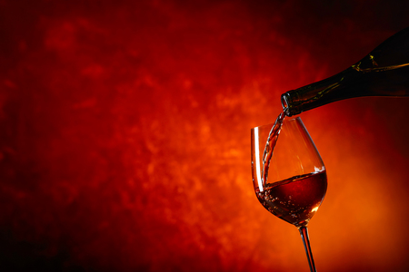 Glass of wine being poured from a bottle . Copy space  .の写真素材