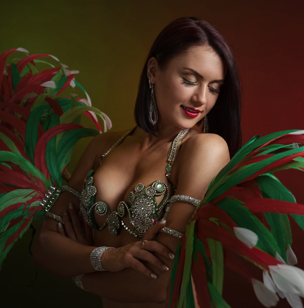  Beautiful woman in  in carnival costume with rhinestones and feathers . の写真素材