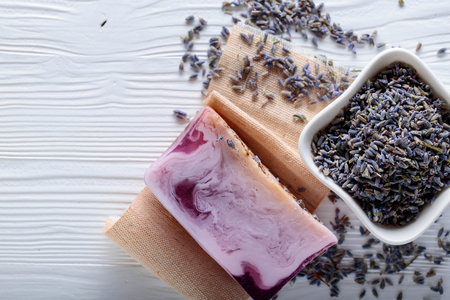 Bar of natural organic soap with lavender on white wooden background. Handmade soap making. Spa products and skin care concept. Copy space.の写真素材