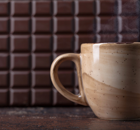 Cup of hot chocolate and a bar of dark bitter chocolate. Copy space for your text.の写真素材