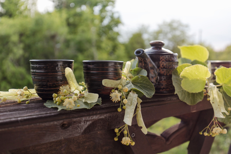 Linden tea and flowers on wooden table.の写真素材