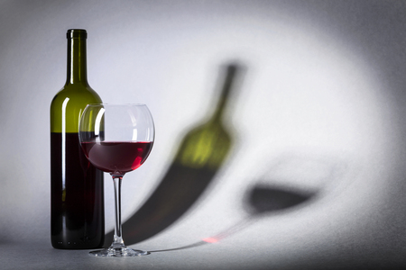 Glass and bottle of red wine, copy space for your text.の写真素材