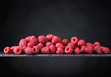 Ripe raspberry  on a black background. Copy space.