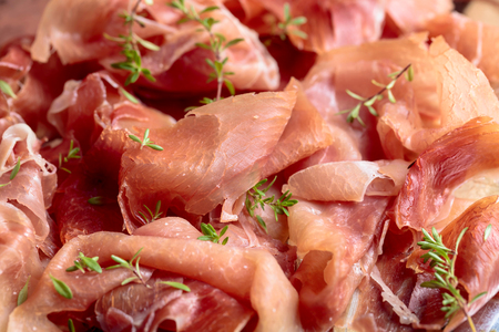 Italian prosciutto crudo or jamon with thyme , selective focus .の写真素材