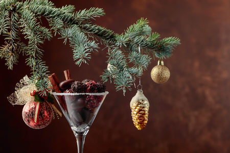 Assortment of fine chocolate candies in goblet. Christmas decoration with cinnamon sticks and chocolate. Still life of Christmas holidays. Copy space.の写真素材
