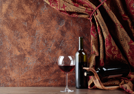 Red wine on a old wooden table. Copy space.の写真素材