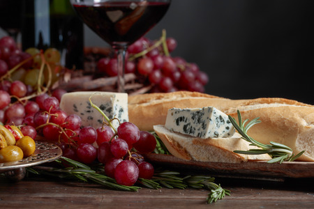 Sandwich with blue cheese and rosemary on a dark background. Delicious snack and red wine. Copy space for your text.の写真素材