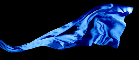 Smooth elegant blue transparent cloth isolated on black background. Texture of flying fabric.の写真素材