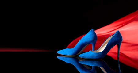 Blue women's corduroy shoes on a black reflective background. Copy space.の写真素材