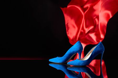 Blue women's corduroy shoes on a black reflective background. Copy space.の写真素材