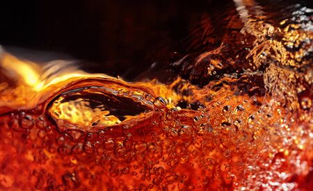 Alcoholic drink on a dark background, abstract splashing. Macro shot.の写真素材