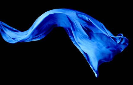Smooth elegant blue transparent cloth isolated on black background. Texture of flying fabric.の写真素材