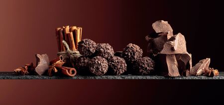 Chocolate truffles with broken pieces of chocolate and spices. Chocolate, cinnamon sticks and anise...