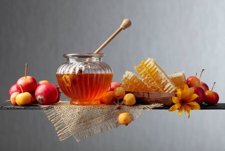 Honey and ripe small wild apples. Red and yellow crab apples, healthy organic food.の写真素材