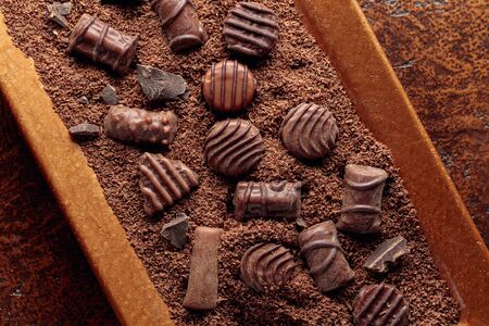 Chocolate candies in chocolate chips. Top view.