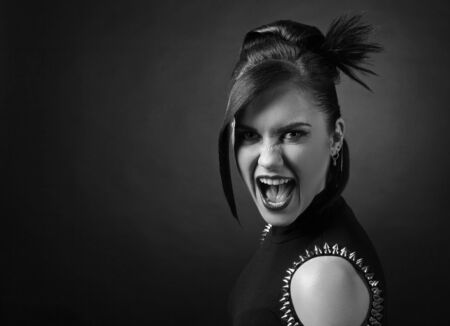Portrait of attractive woman in punk style. Beautiful brunette with perfect hairstyle and...