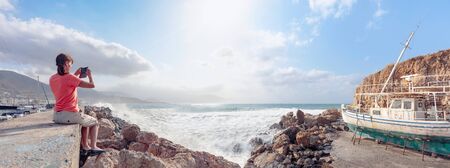 Old broken wooden ship on the seashore. Sunny summer day on a Mediterranean sea. Panoramic view.の写真素材