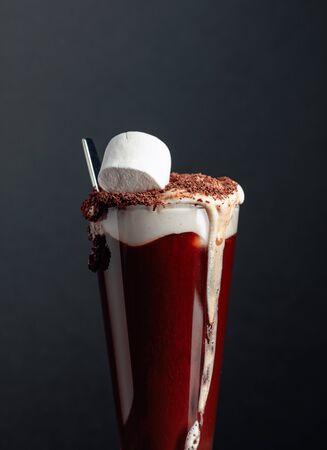 Hot chocolate with marshmallows sprinkled with chocolate crumbs. Black background. Copy space.の写真素材