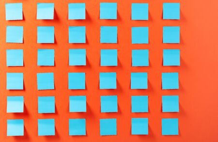 Blue empty stickers on a orange background. Free space for your text.