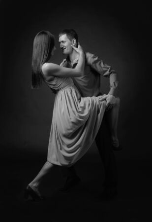 Couple in love dancing in the Studio. Black and white.の写真素材