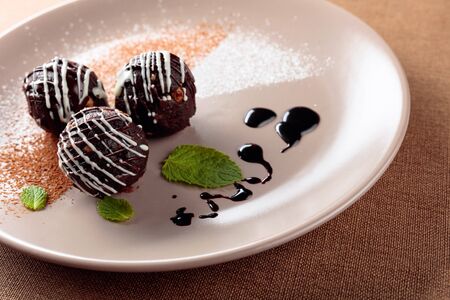 Chocolate balls with mint on a beige plate. Selective focus.の写真素材