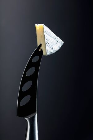 Soft cheese on a knife. Copy space.の写真素材