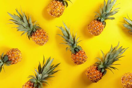 Ripe and juicy pineapples on a yellow background.の写真素材