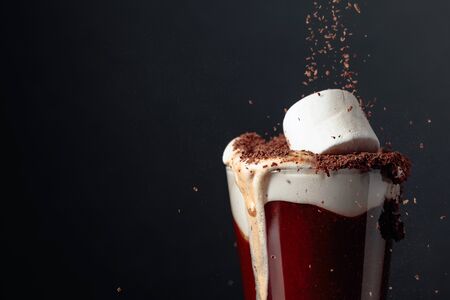 Hot chocolate with marshmallows. Black background. Copy space.の写真素材