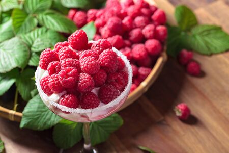 Raspberry dessert with ripe juicy berries on a old wooden table.の写真素材