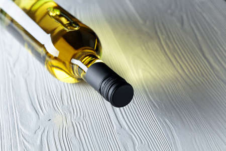 An unopened bottle of white wine on an old wooden background. Copy space.