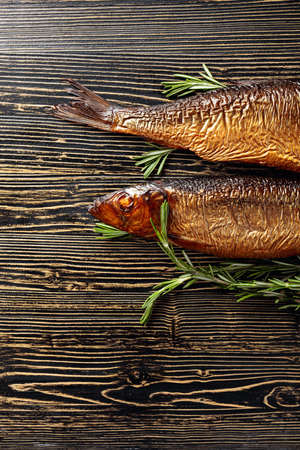 Smocked herring on an old wooden table. Traditional food in the Baltic counties. Top view.の写真素材