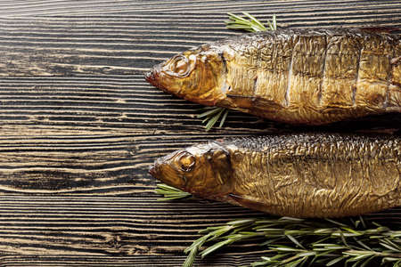 Smocked herring on an old wooden table. Traditional food in the Baltic counties. Top view.の写真素材
