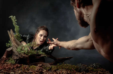 The young man rescues the girl by holding out his hand to her. The image on the theme of the...