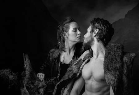 A couple in love, saying goodbye in the backdrop of a dark mountain landscape. Image on the theme of the Apocalypse. Black and white.の写真素材