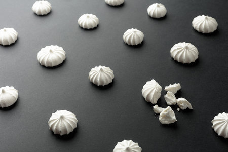 Small white meringues on the table. Selective focus.の写真素材