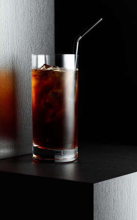 Iced coffee in frozen glass on a black table.