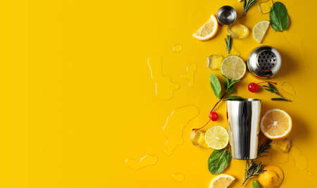 Shaker with ingredients for making cocktails. Yellow background with copy space. Top view.の写真素材