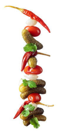 Preserved vegetables isolated on white background. Marinated cucumbers, tomatoes, peppers, and onions garnished with green coriander leaves.の写真素材