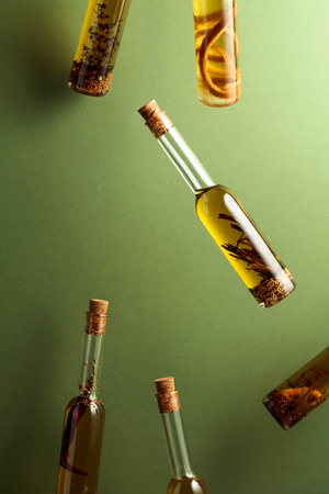 Bottles of homemade olive oil with spices and herbs. Copy space.の写真素材