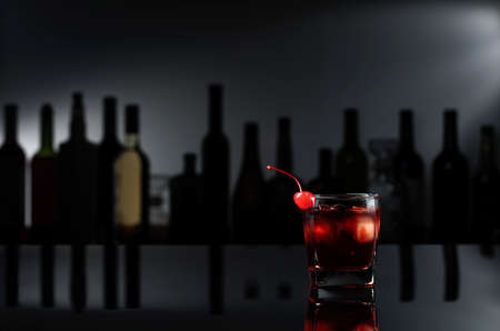 Cocktail "Manhattan" on a black reflective background. Copy space.の写真素材
