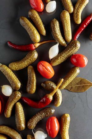 Preserved vegetables. Marinated cucumbers, tomatoes, peppers, and onions. Top view.