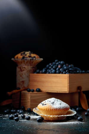 Blueberry muffins and berries in a wooden box. Copy space.の写真素材