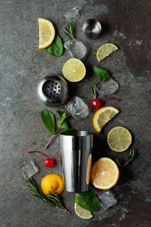 Shaker with ingredients for making cocktails. Grey stone table. Top view.の写真素材