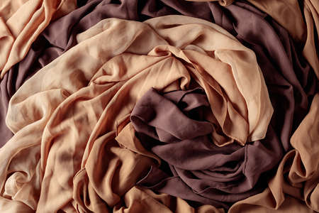 Background with smooth beige and brown satin fabric. Top view.の写真素材