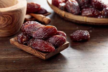 Juicy dates on a old wooden table.